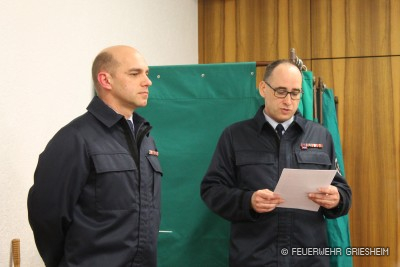 Stadtbrandinspektor Bert Hentzler verließt eine Laudatio über Sven Schwiderek vor dessen Ehrung